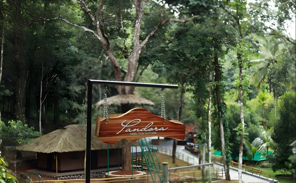 Pandora Resort Kudayathoor entrance sign surrounded by lush greenery near Vagamon Kerala